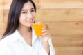 Attractive beautiful asian woman is drinking orange juice. Charm Royalty Free Stock Photo